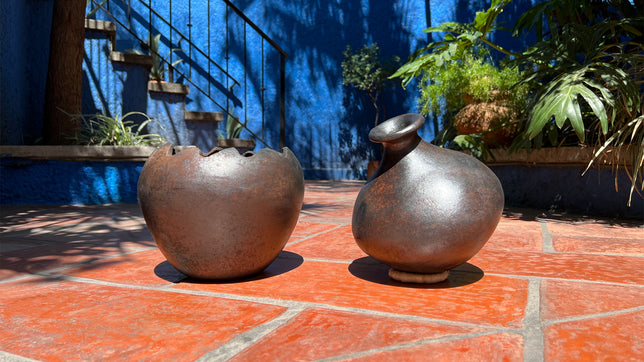 Saltillo tiled floor of outdoor patio in Mexico with Cocucho pots in center.
