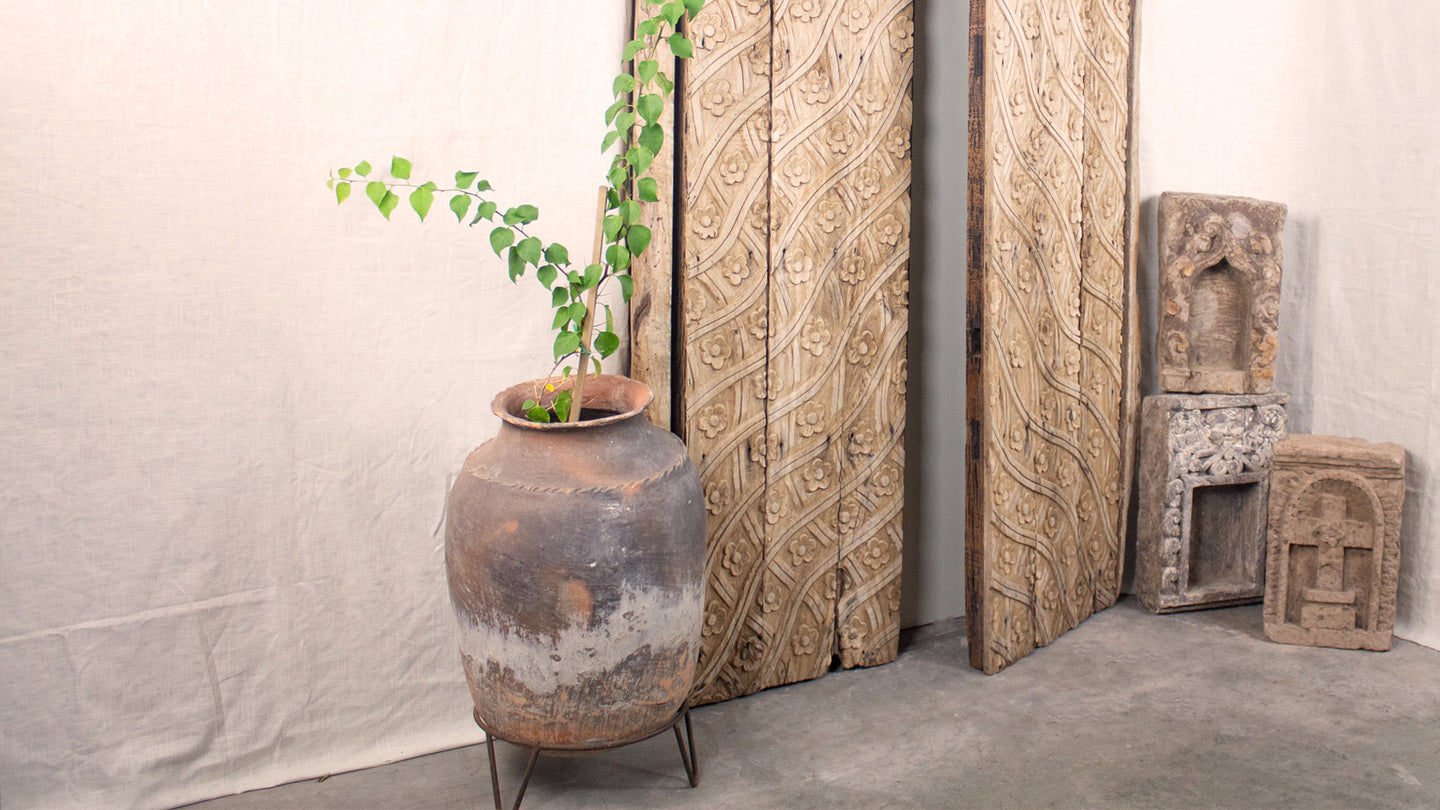 Artifacts, terracotta pot, carved wood door, stone niche mantles