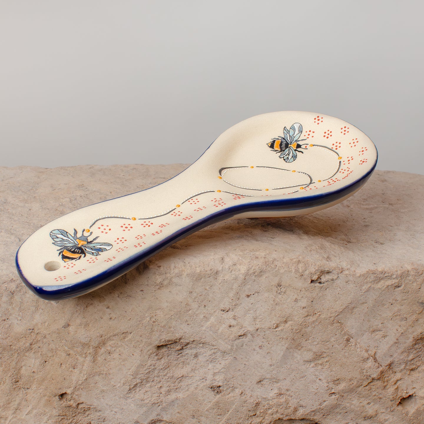 Ceramic spoon rest with bumble bee pattern hand painted.