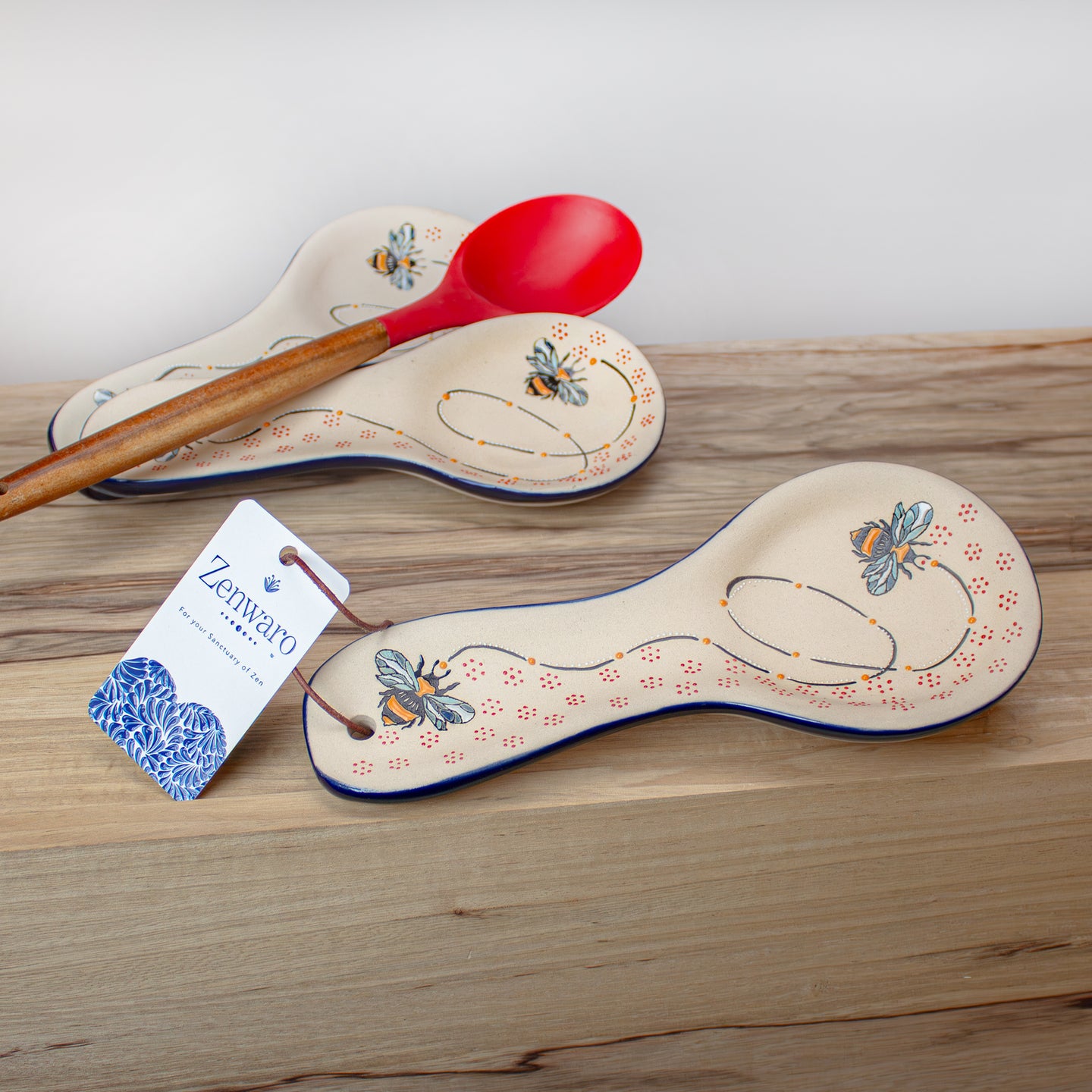 Ceramic spatula rest with Zenwaro branding on kitchen counter.
