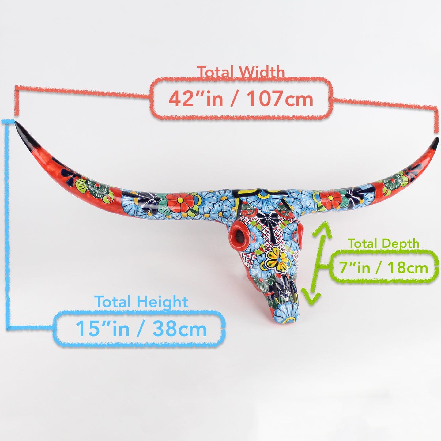 Decorative bull skull with Talavera patterns and measurements.