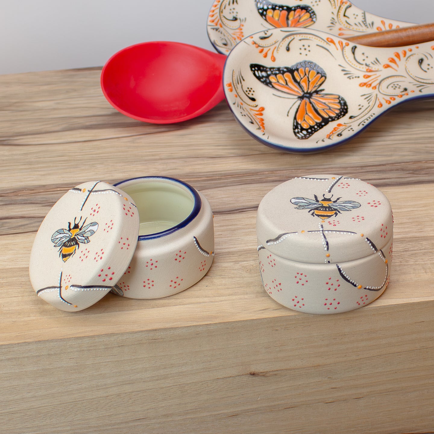 Salt Cellar / Spice Caddy, Ceramic container with bee and butterfly designs on kitchen counter.