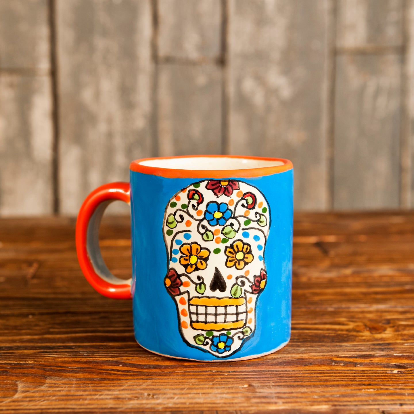 Talavera ceramic mug with handle and Dia de los Muertos designs.