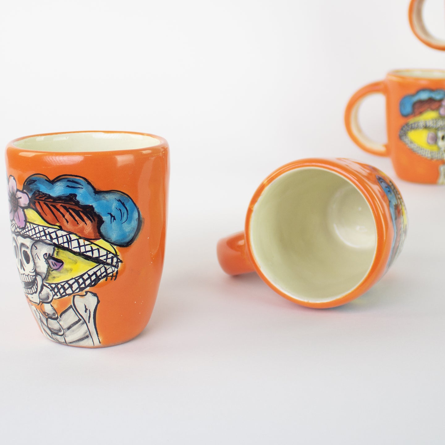 Colorful ceramic mug with artistic Catrina and day of the dead art.