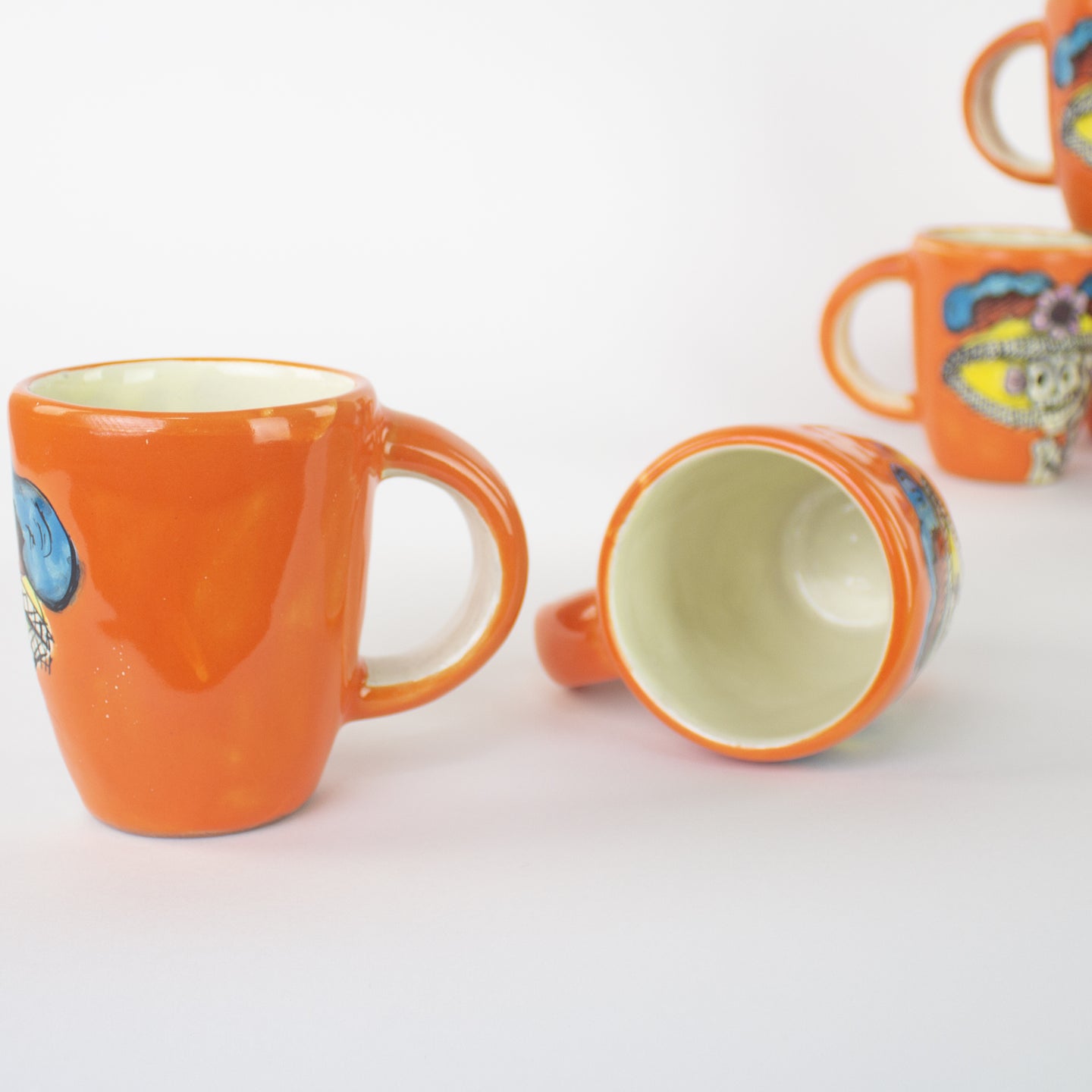 Orange mug with hand painted Catrina artwork.