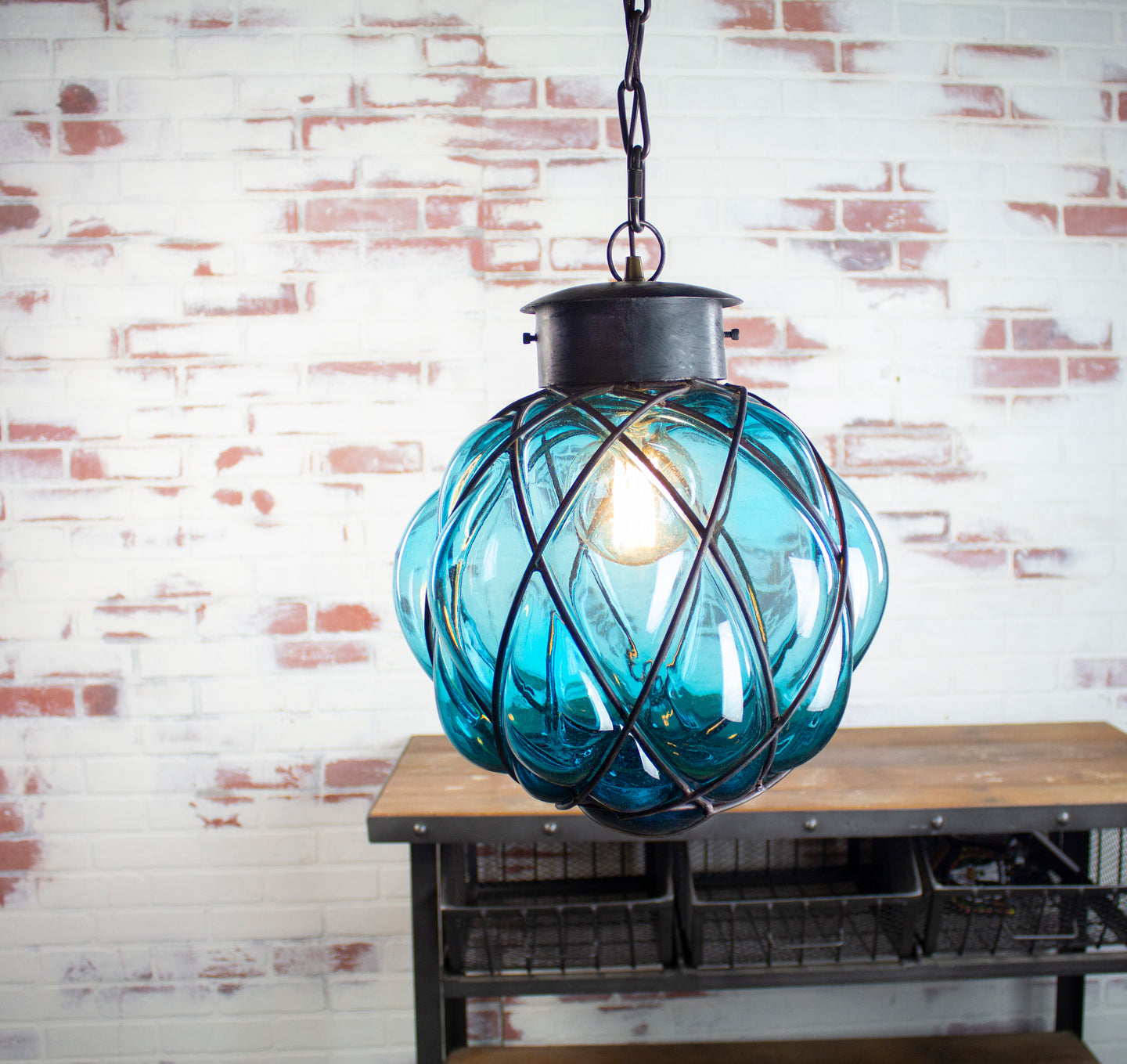 Blue glass pendant light fixture with Costal theme.