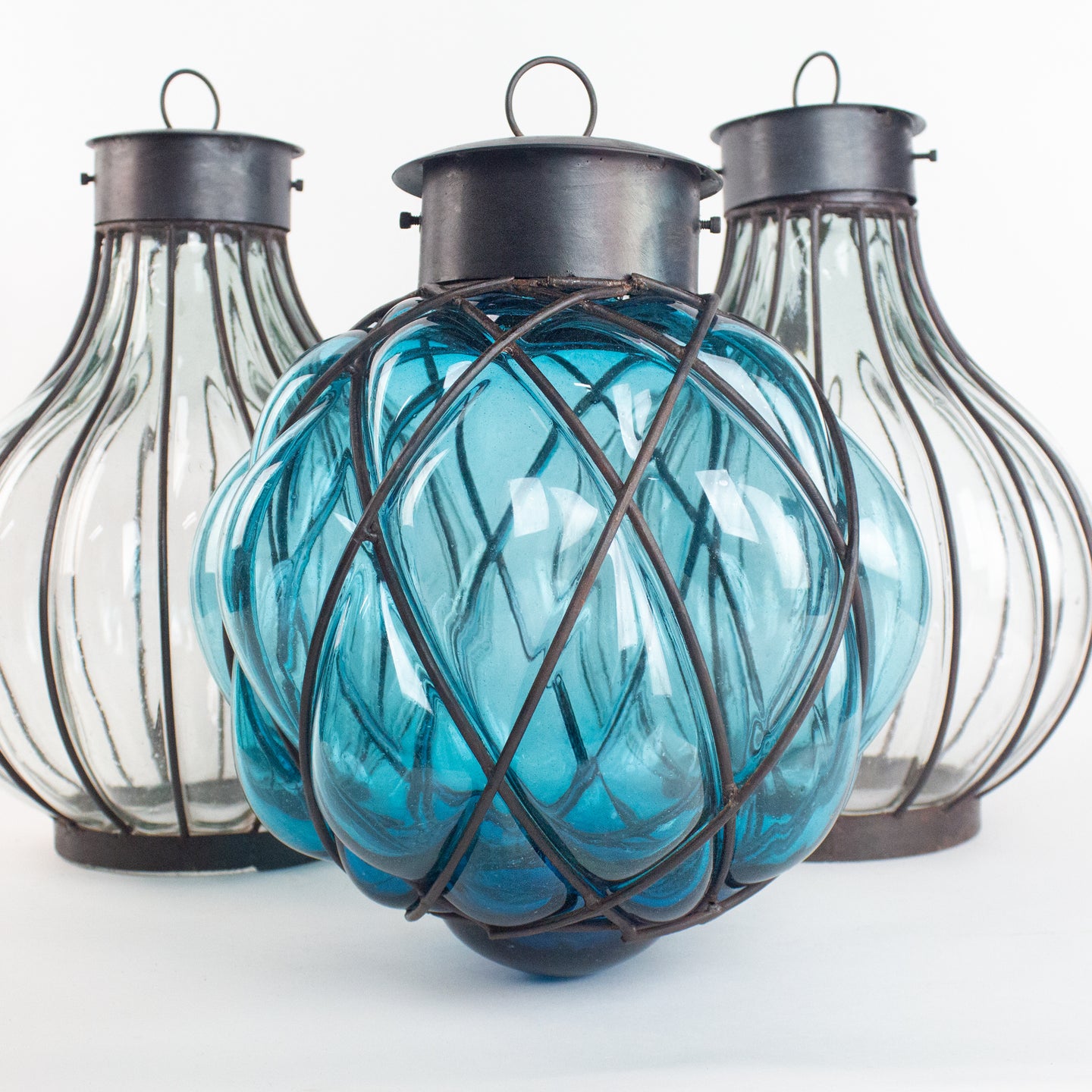 Costal theme blue glass pendant light with metal cage.