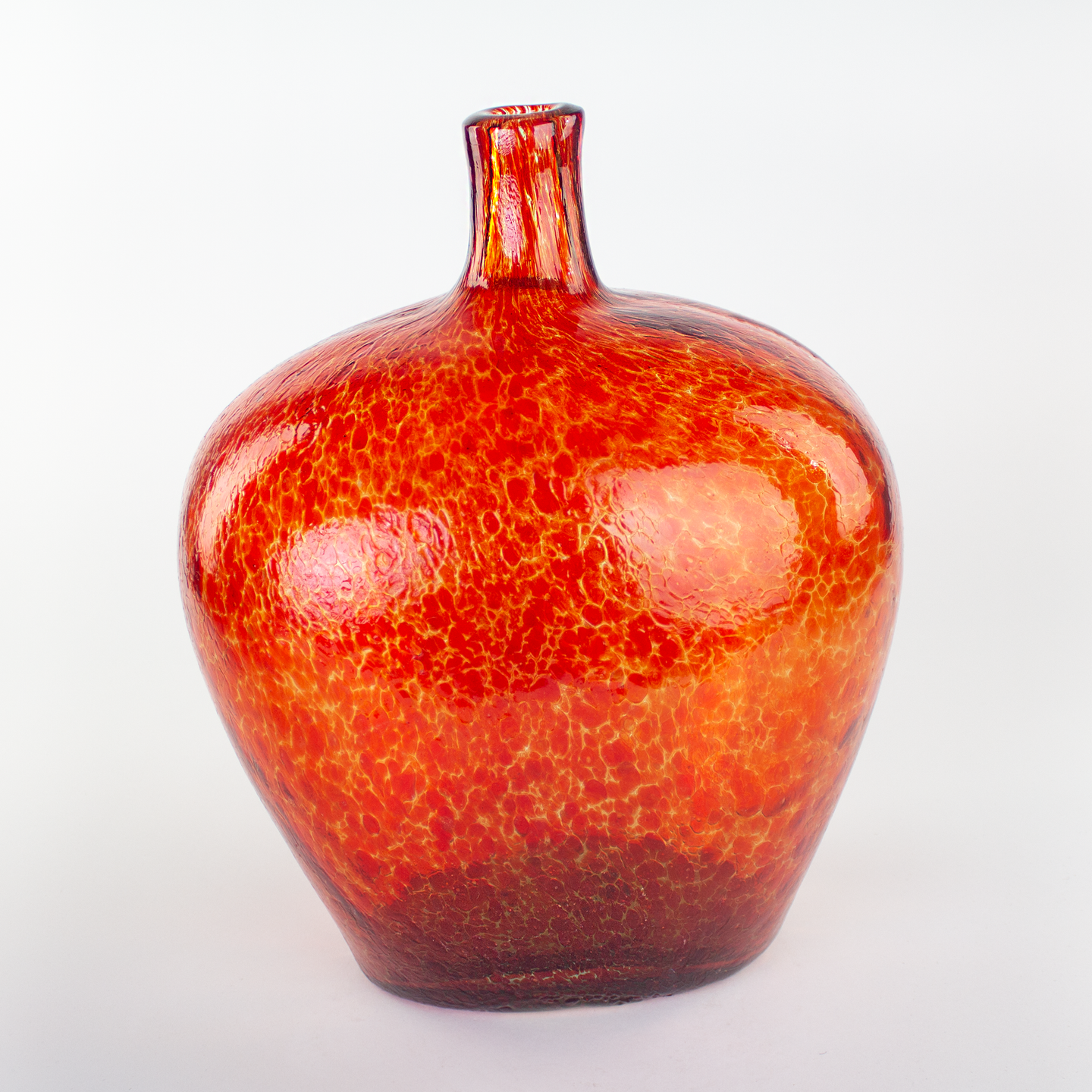 Decorative giant blown glass bottle textured red pattern.