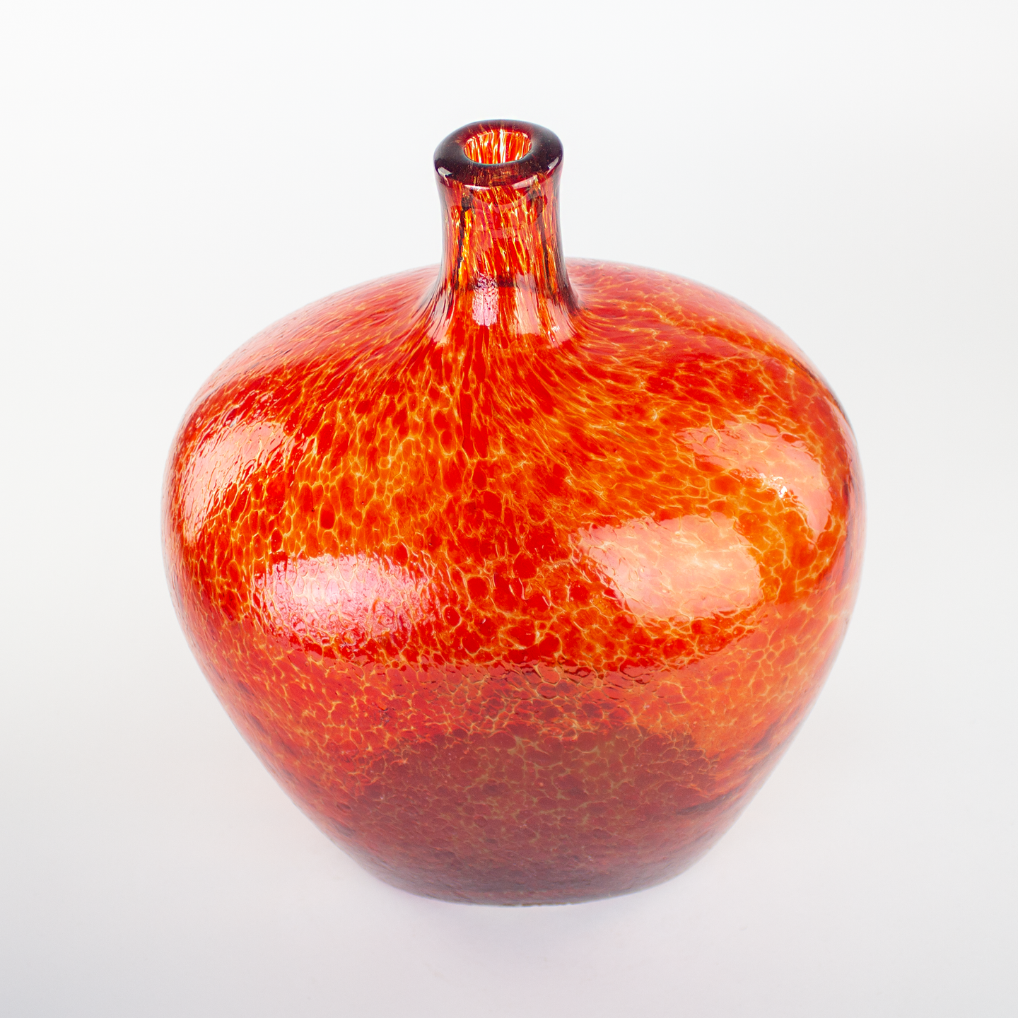 Oversized Red glass vase with a textured surface.