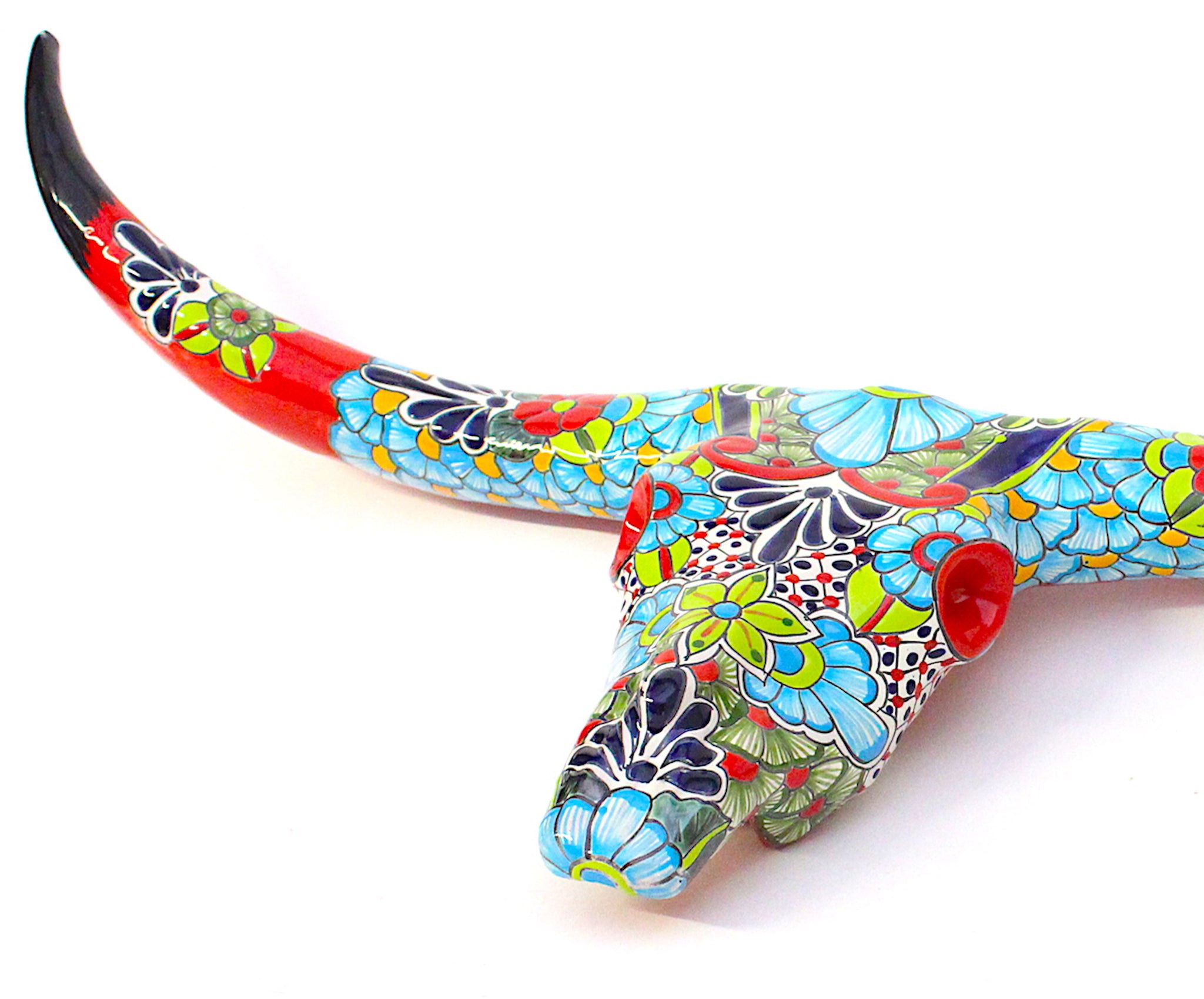 Wall hanging cow skull sculpted from ceramic artisan painted with Talavera patterns. Talavera pottery.